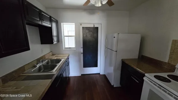 a kitchen with a sink stove and refrigerator
