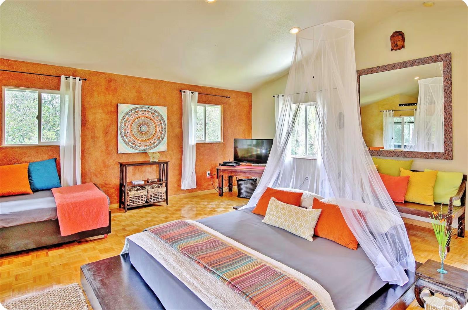 18-4011 Makuahine Road Mountain View, HI 96771 - Photo 11 of 24 a bedroom with a bed and wooden floor