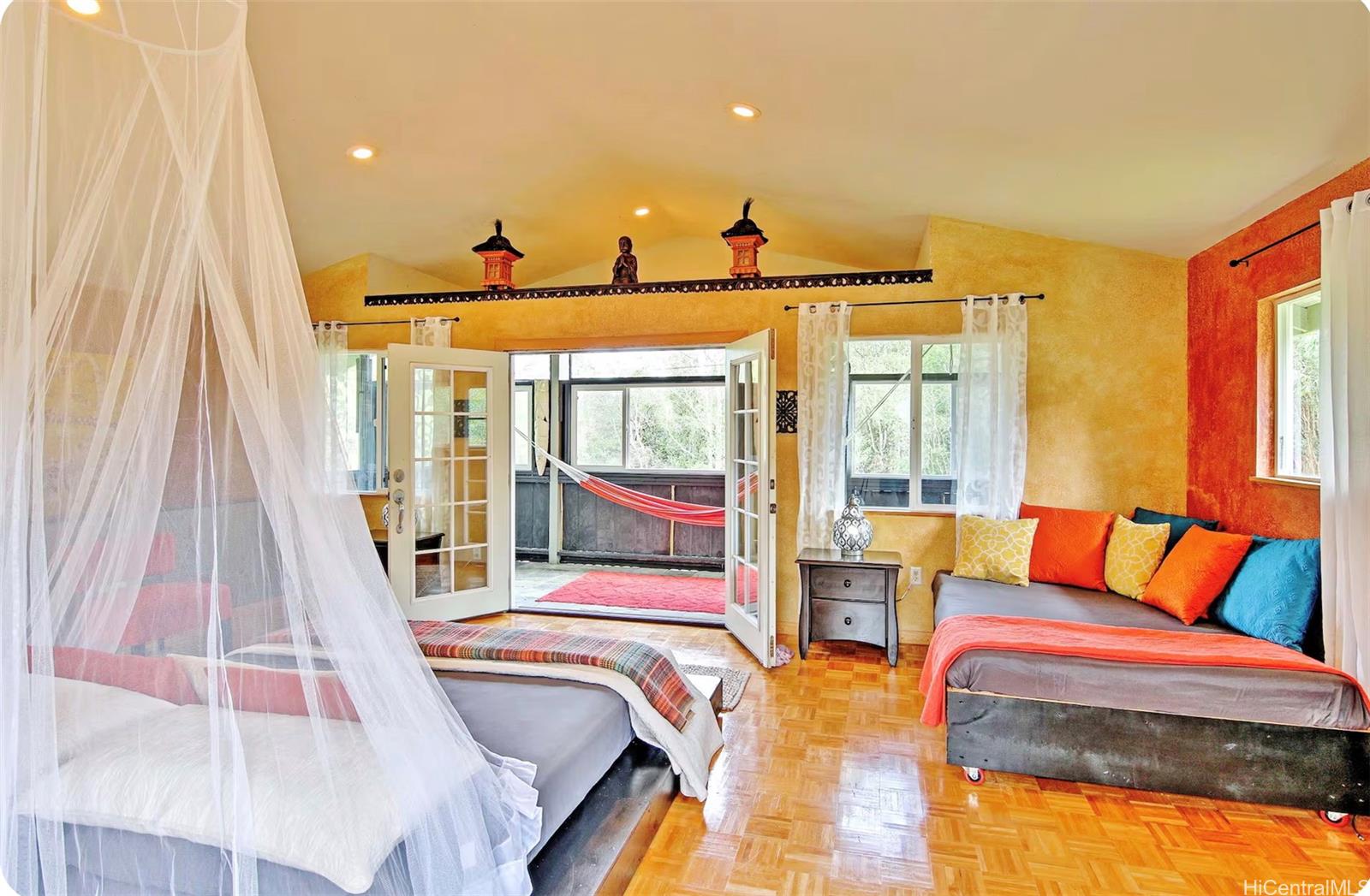 18-4011 Makuahine Road Mountain View, HI 96771 - Photo 12 of 24 a bedroom with furniture and a large window