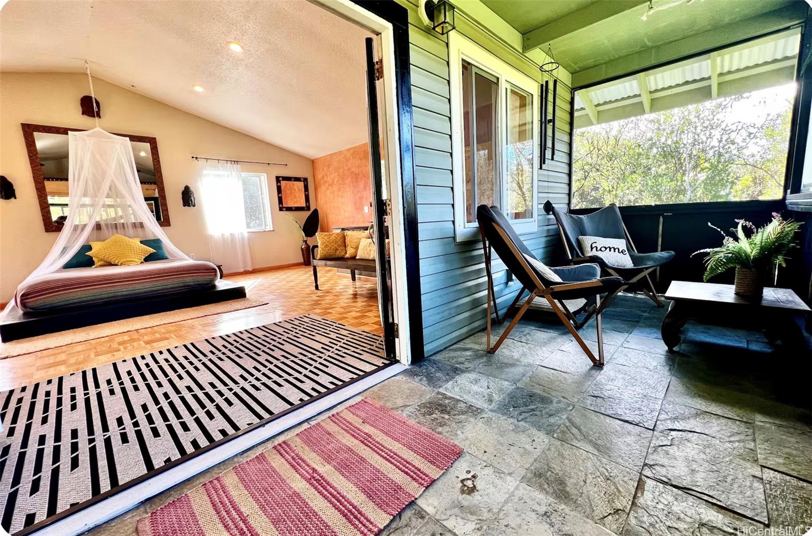 18-4011 Makuahine Road Mountain View, HI 96771 - Photo 13 of 24 a balcony view with a dining table and chairs with wooden floor