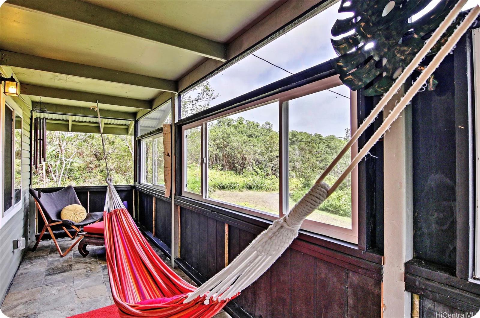 18-4011 Makuahine Road Mountain View, HI 96771 - Photo 14 of 24 a room with balcony and wooden floor