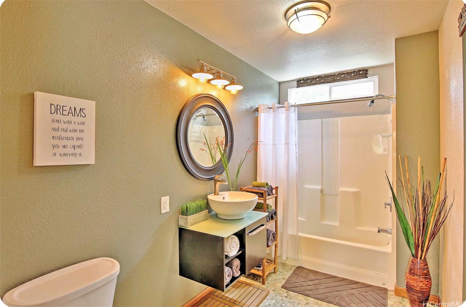18-4011 Makuahine Road Mountain View, HI 96771 - Photo 16 of 24 a bathroom with a toilet a sink and a shower