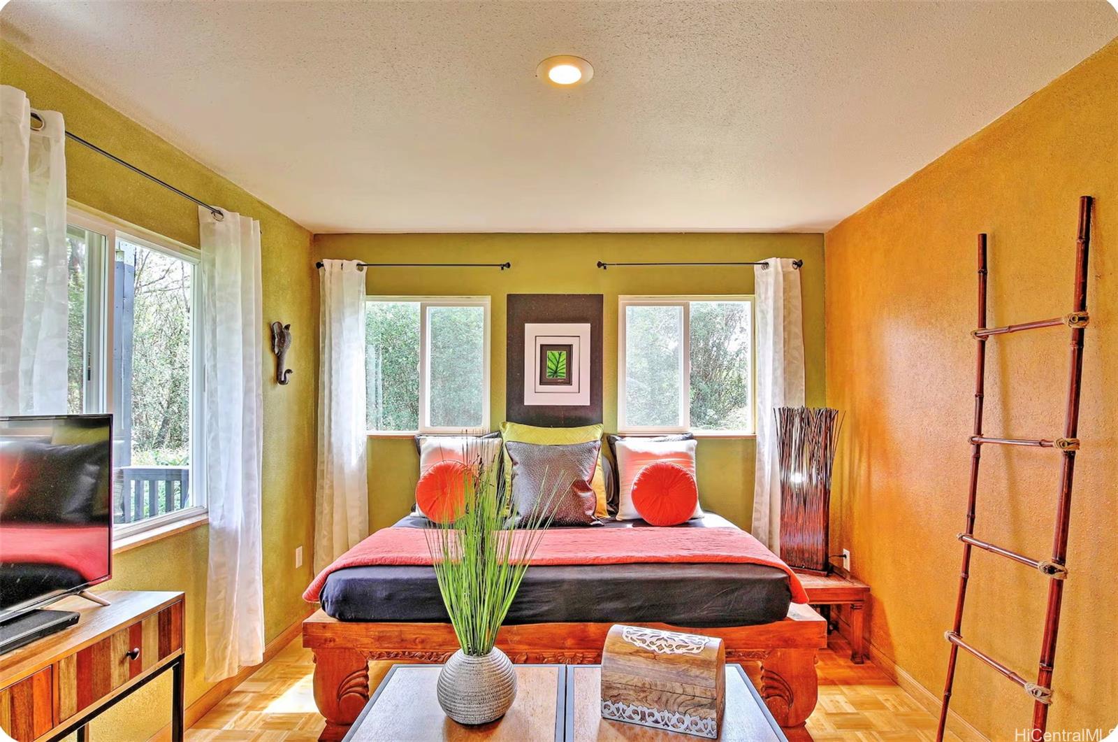 18-4011 Makuahine Road Mountain View, HI 96771 - Photo 6 of 24 a living room with furniture a flat screen tv and next to a window