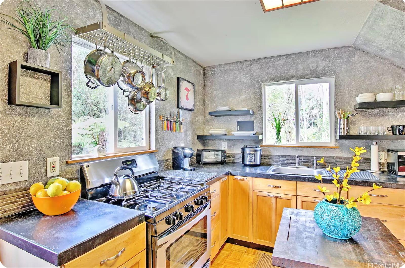 18-4011 Makuahine Road Mountain View, HI 96771 - Photo 7 of 24 a view of a kitchen with kitchen island dining table and a couch