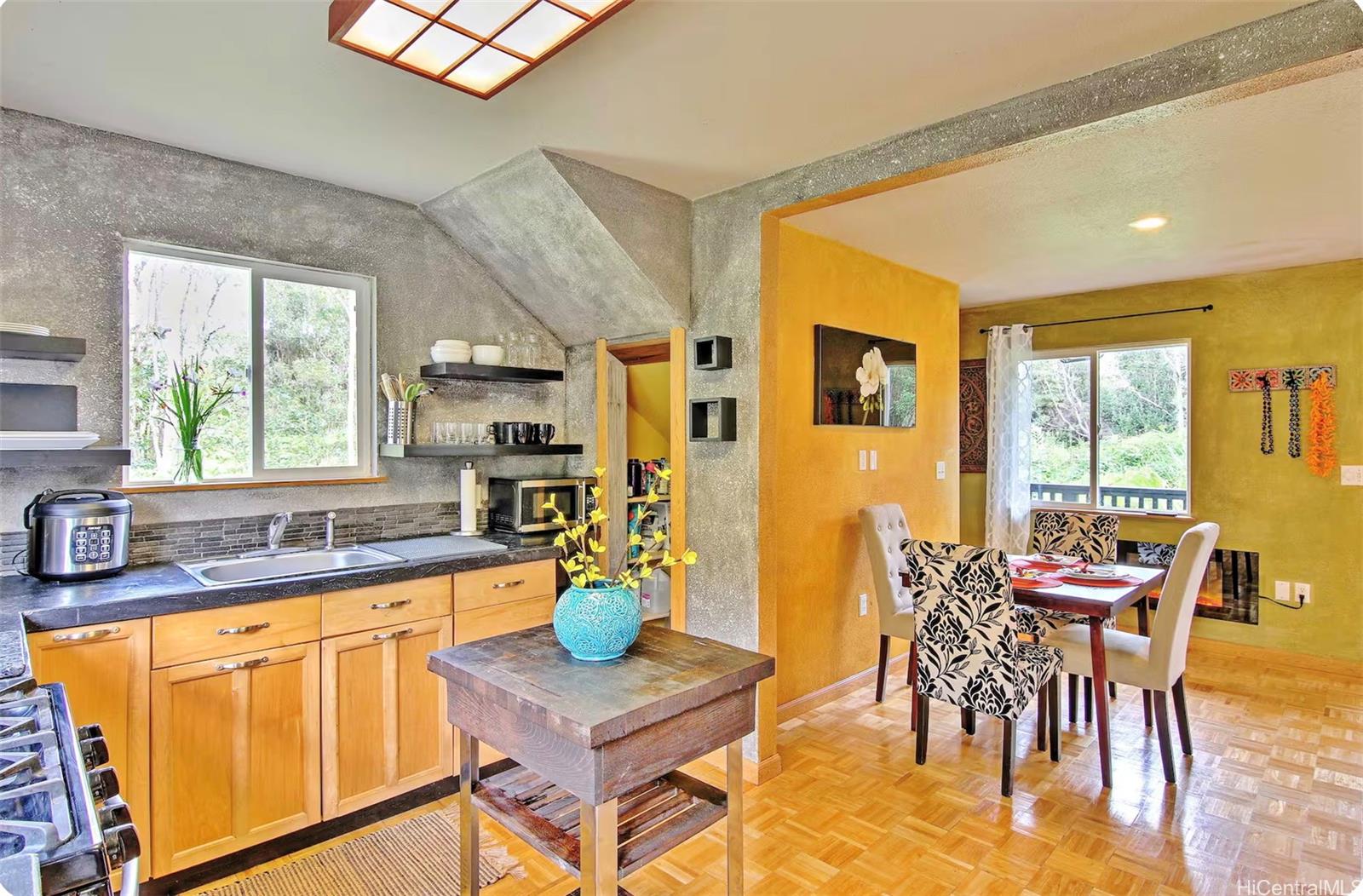 18-4011 Makuahine Road Mountain View, HI 96771 - Photo 8 of 24 a view of a dining room with furniture and a kitchen area