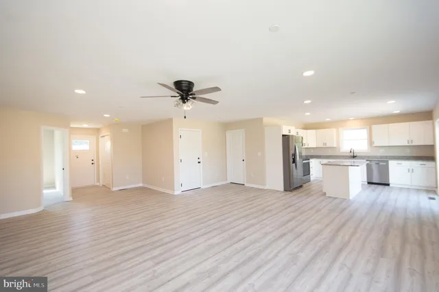 a view of a kitchen with a sink and wooden floor