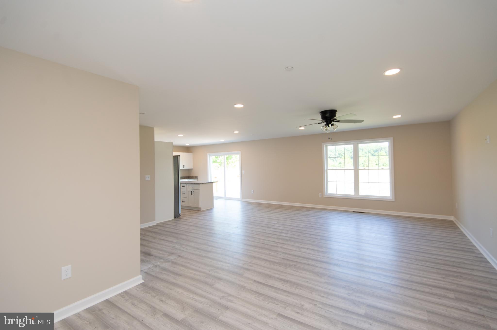 Wrights Rest Road Hurlock, MD 21643 - Photo 12 of 25 a view of a big room with wooden floor and windows