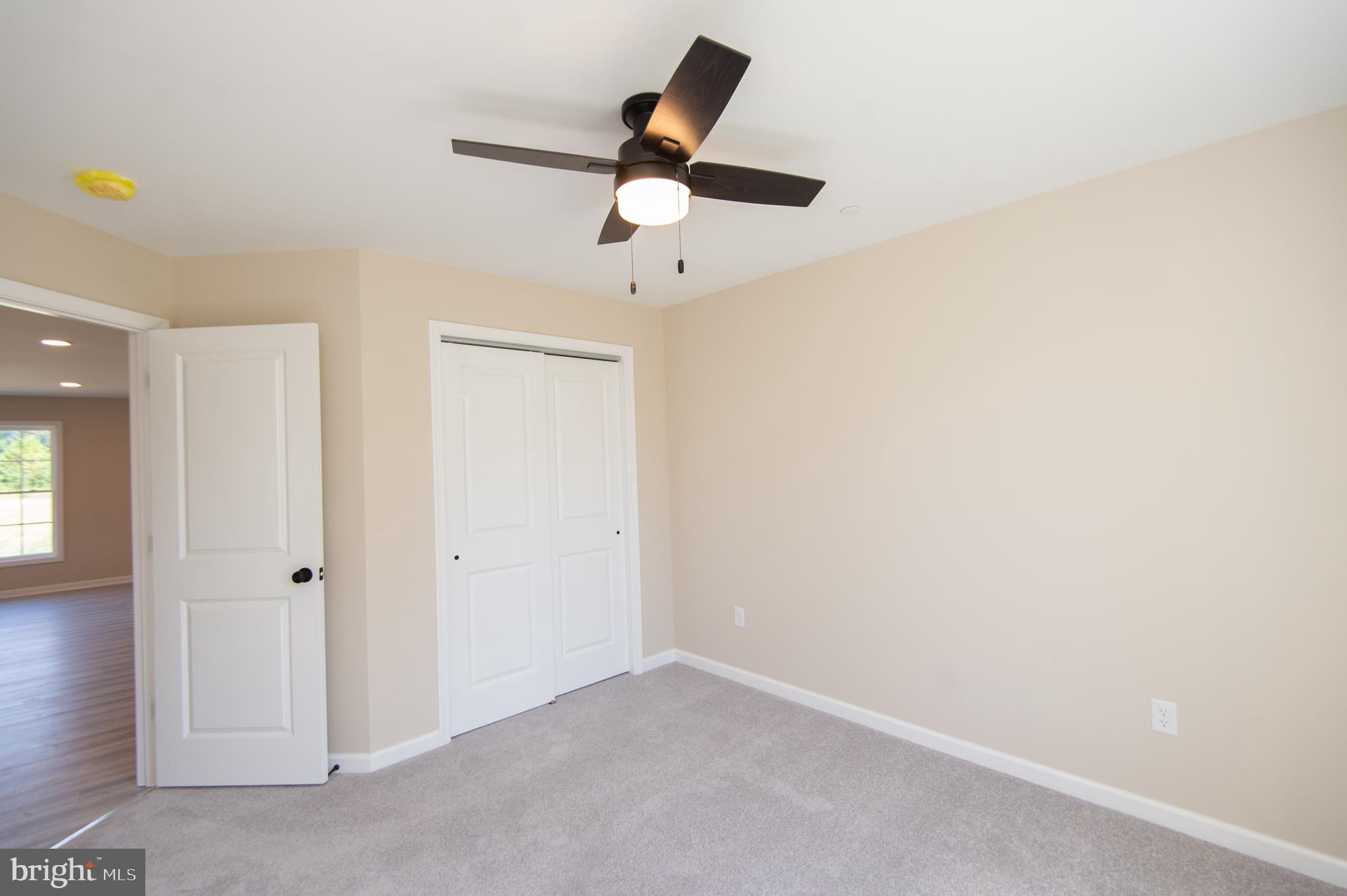 Wrights Rest Road Hurlock, MD 21643 - Photo 14 of 25 an empty room with ceiling fan and window