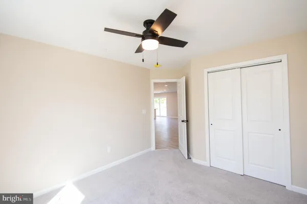 a view of empty room with ceiling fan