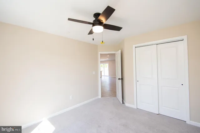 a view of empty room with ceiling fan