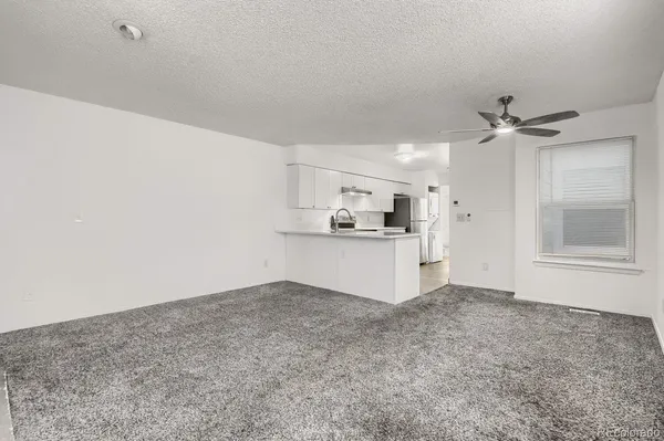 a view of a kitchen with a sink and cabinets