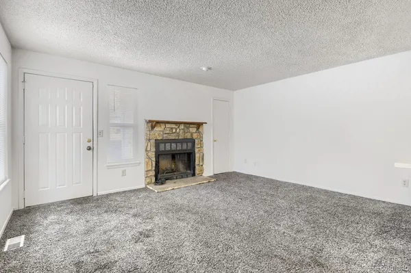 an empty room with a fireplace