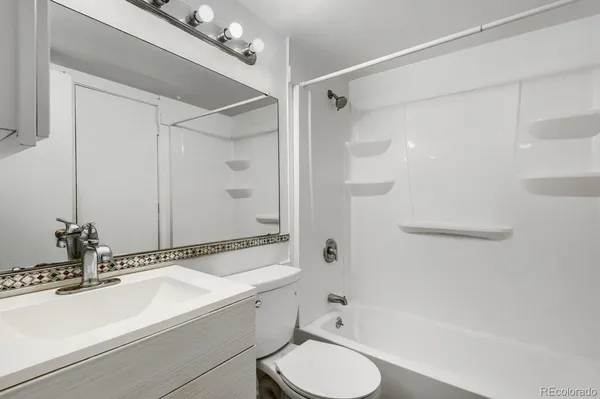 a bathroom with a sink toilet double vanity and shower