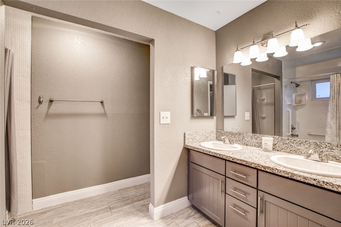 4367 South Mojave Road Las Vegas, NV 89121 - Photo 29 of 53 Double vanity with stone counters provides ample space and elegant appeal.