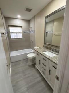 1570 Sutter Street Dallas, TX 75216 - Photo 14 of 17 a bathroom with a granite countertop sink a toilet a mirror and bathtub