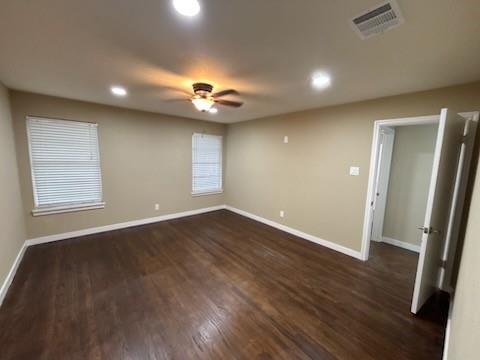 1570 Sutter Street Dallas, TX 75216 - Photo 4 of 17 an empty room with wooden floor and windows