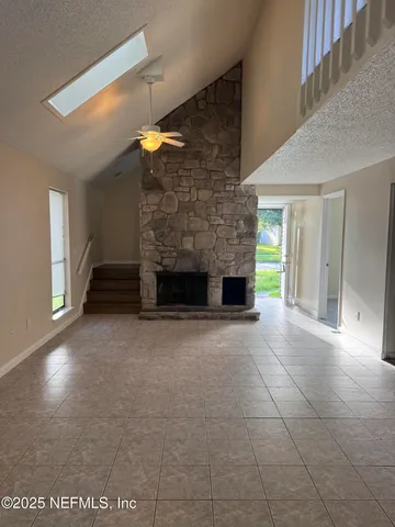 a view of empty room with a fireplace