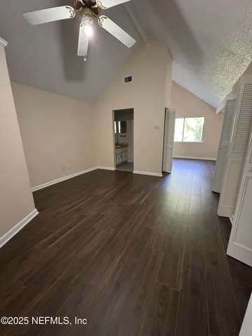 an empty room with wooden floor and closet