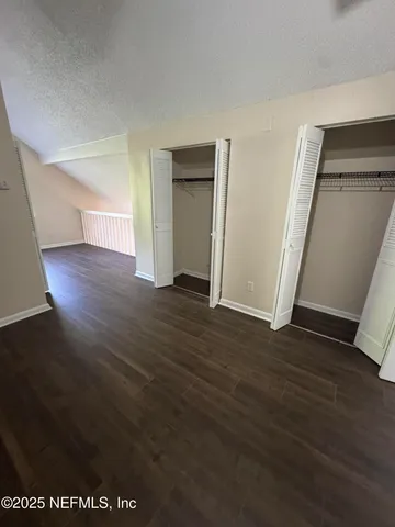 a bathroom with a granite countertop sink a mirror and a shower