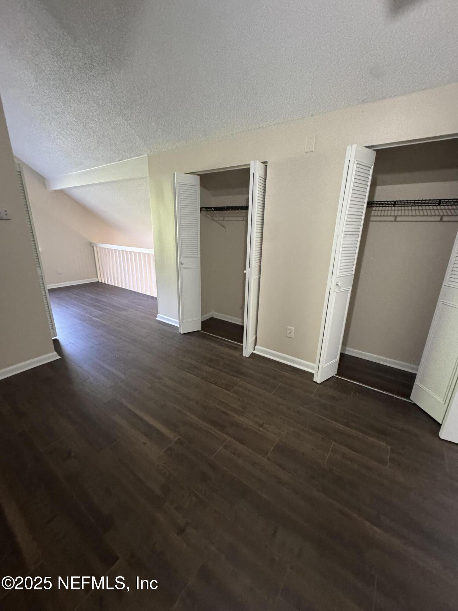10244 Pine Breeze Road South Jacksonville, FL 32257 - Photo 9 of 16 an empty room with wooden floor and closet