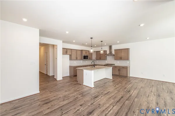 a large kitchen with a lot of counter space and stainless steel appliances
