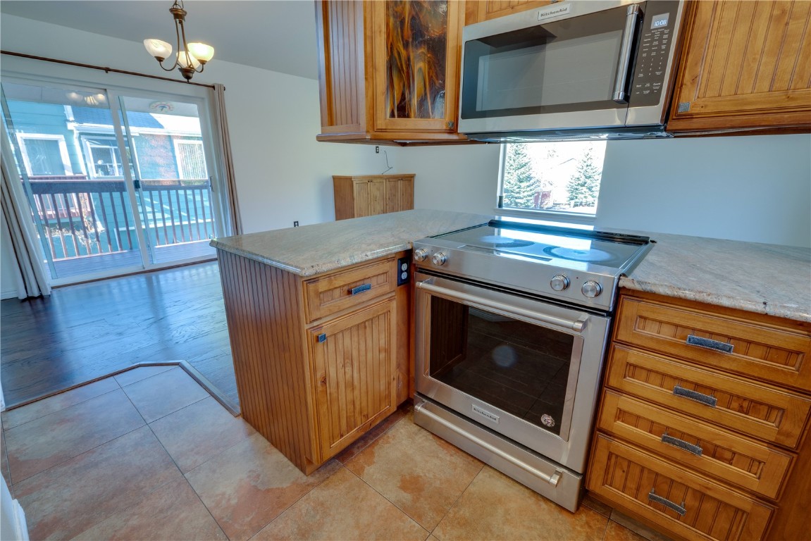 646 Alpine Road Dillon, CO 80435 - Photo 9 of 31 Updated Kitchen, Granite countertops, brand new microwave, electric glass stove top, tile floor.