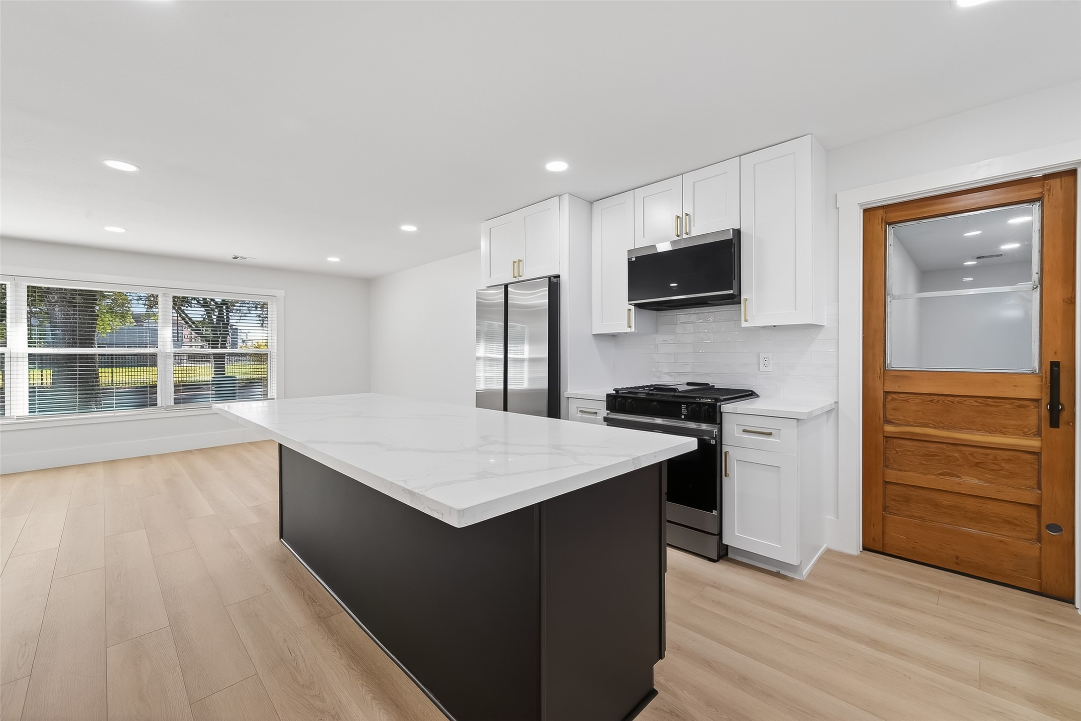 9770 Cedardale Drive Houston, TX 77055 - Photo 14 of 40 a kitchen with a stove and a refrigerator