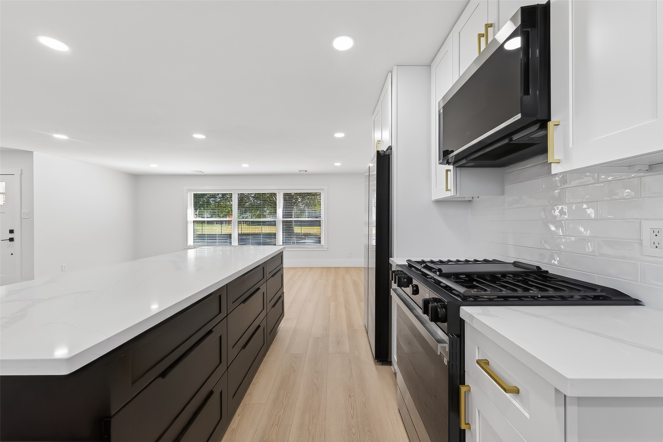 9770 Cedardale Drive Houston, TX 77055 - Photo 18 of 40 a kitchen with granite countertop a stove and a sink