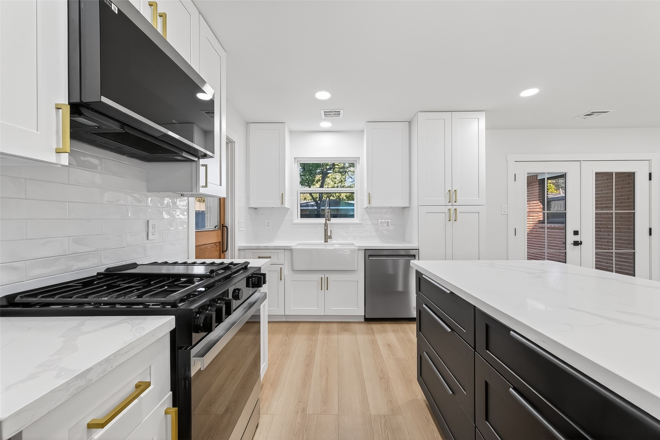 9770 Cedardale Drive Houston, TX 77055 - Photo 20 of 40 a kitchen with a stove sink and cabinets