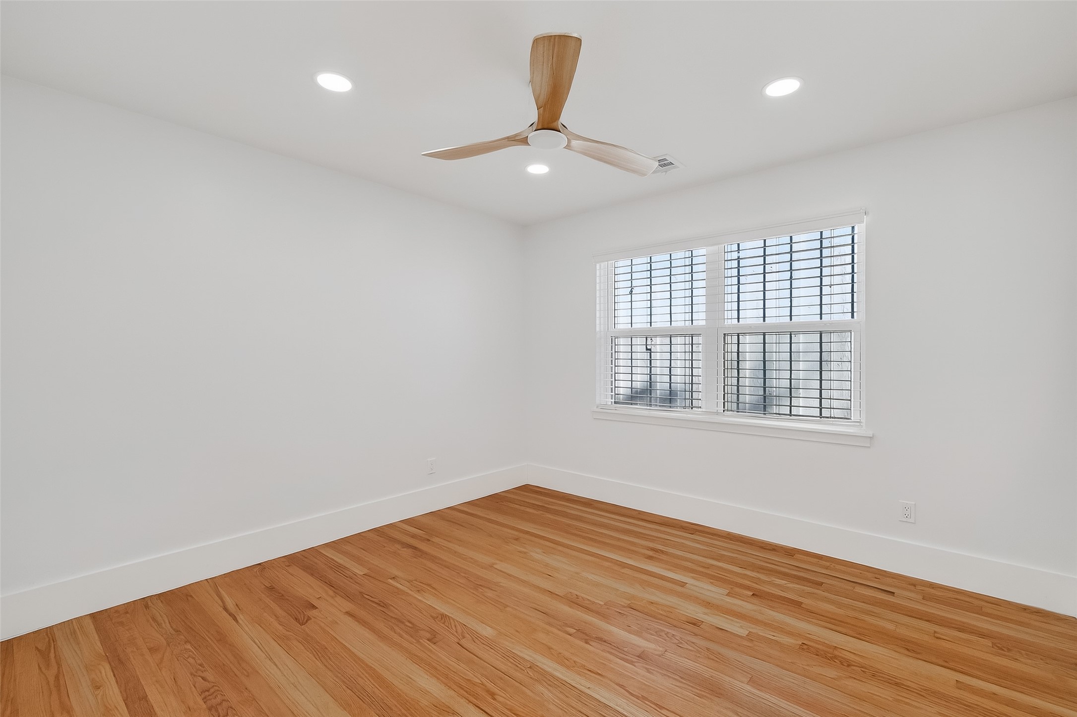 9770 Cedardale Drive Houston, TX 77055 - Photo 22 of 40 wooden floor in an empty room with a window