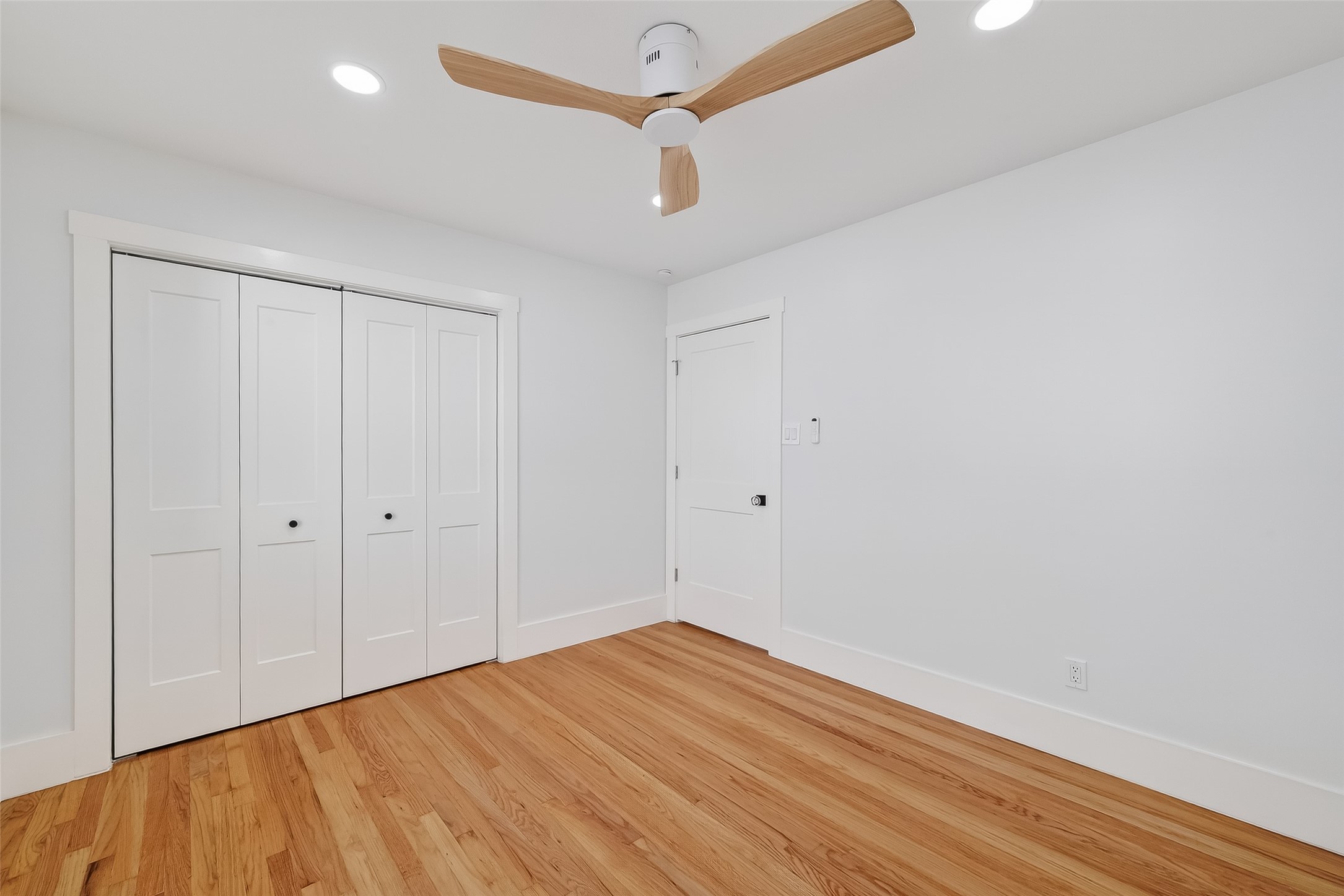 9770 Cedardale Drive Houston, TX 77055 - Photo 23 of 40 a view of empty room with wooden floor and ceiling fan
