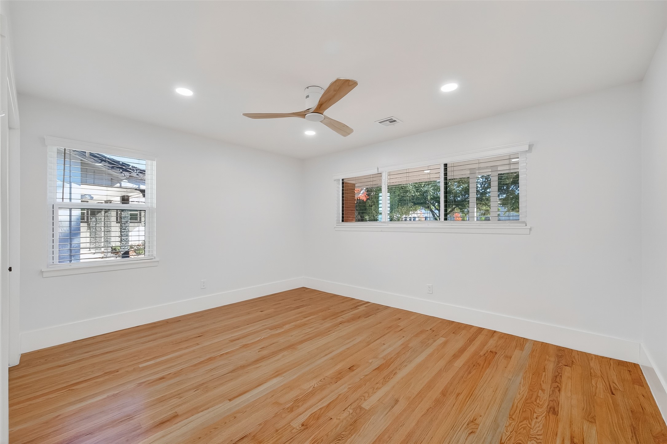 9770 Cedardale Drive Houston, TX 77055 - Photo 28 of 40 a view of empty room with wooden floor and fan