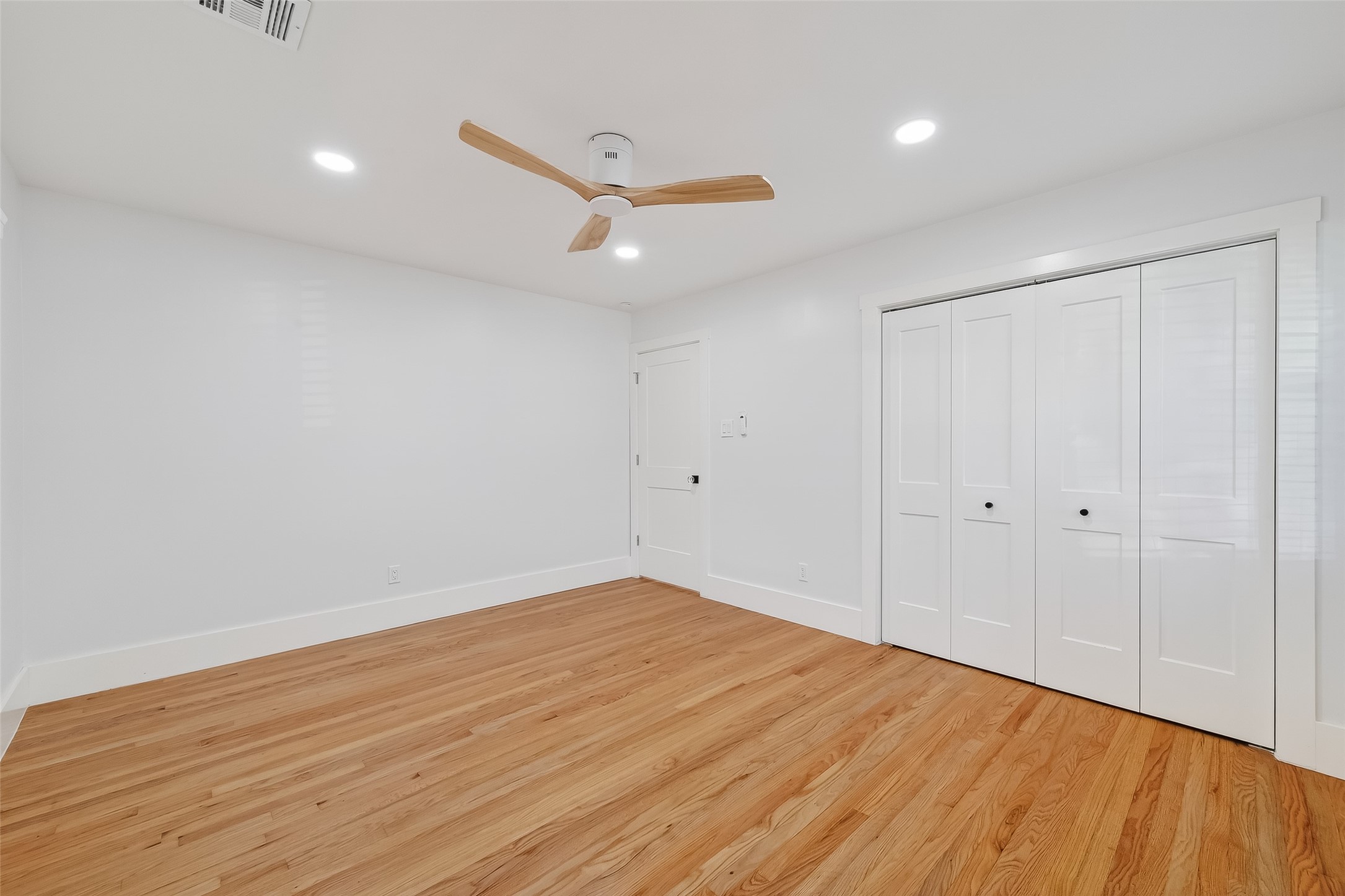 9770 Cedardale Drive Houston, TX 77055 - Photo 29 of 40 an empty room with wooden floor and windows