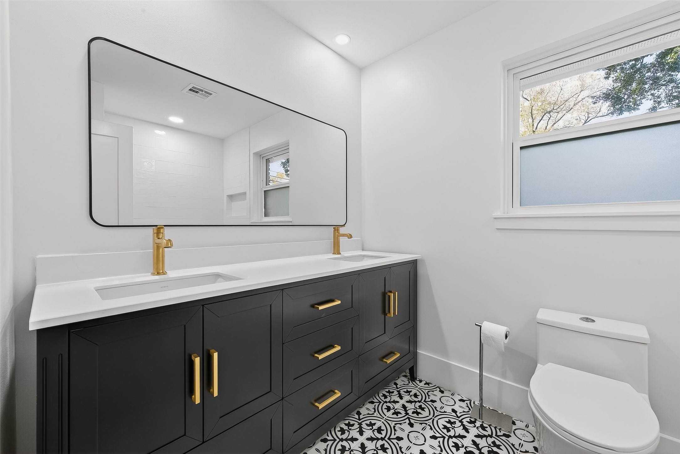 9770 Cedardale Drive Houston, TX 77055 - Photo 30 of 40 a bathroom with a sink a toilet and mirror