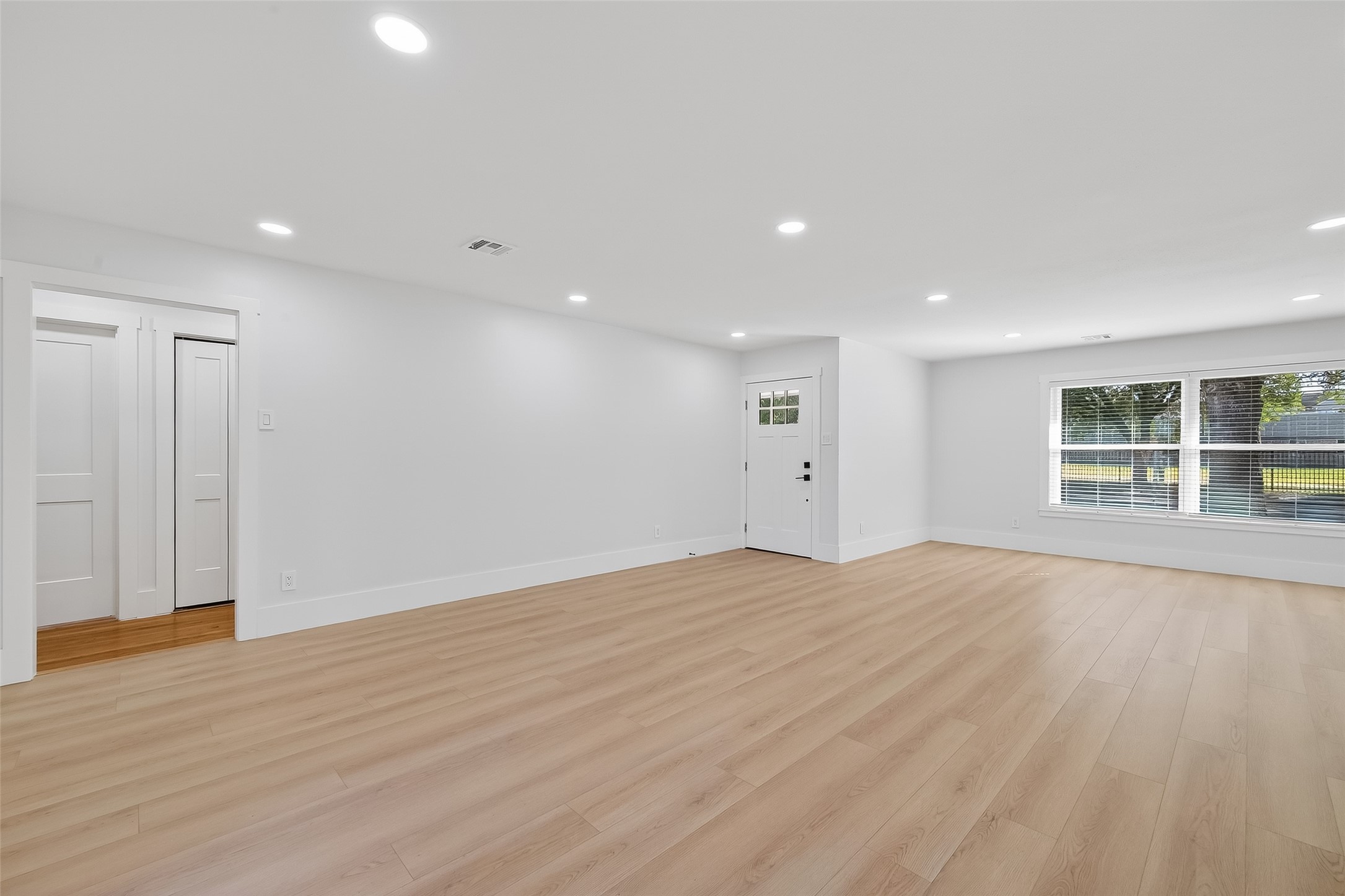 9770 Cedardale Drive Houston, TX 77055 - Photo 6 of 40 a view of empty room with wooden floor and windows