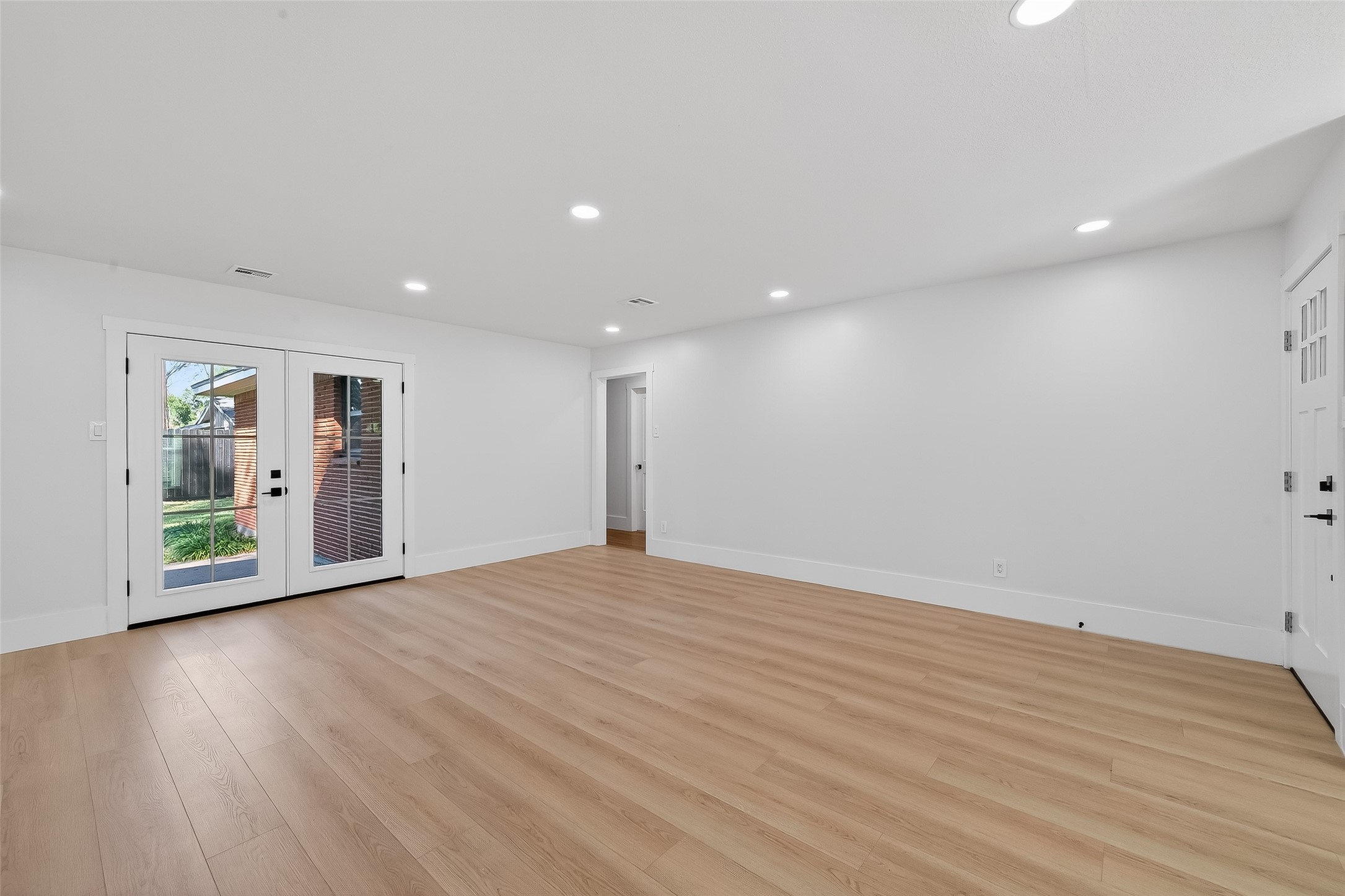 9770 Cedardale Drive Houston, TX 77055 - Photo 7 of 40 a view of an empty room with wooden floor and a window