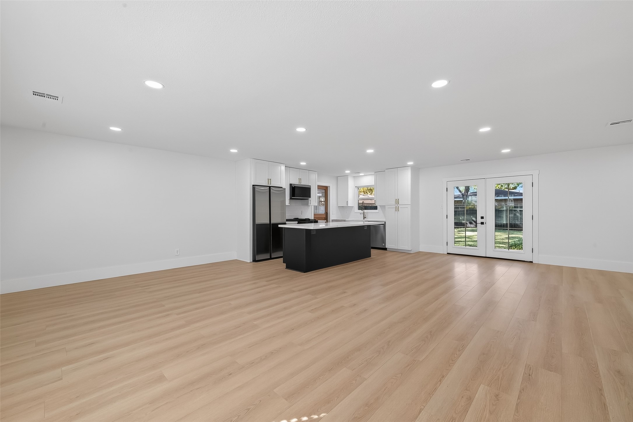 9770 Cedardale Drive Houston, TX 77055 - Photo 9 of 40 a view of a kitchen with a sink and a microwave