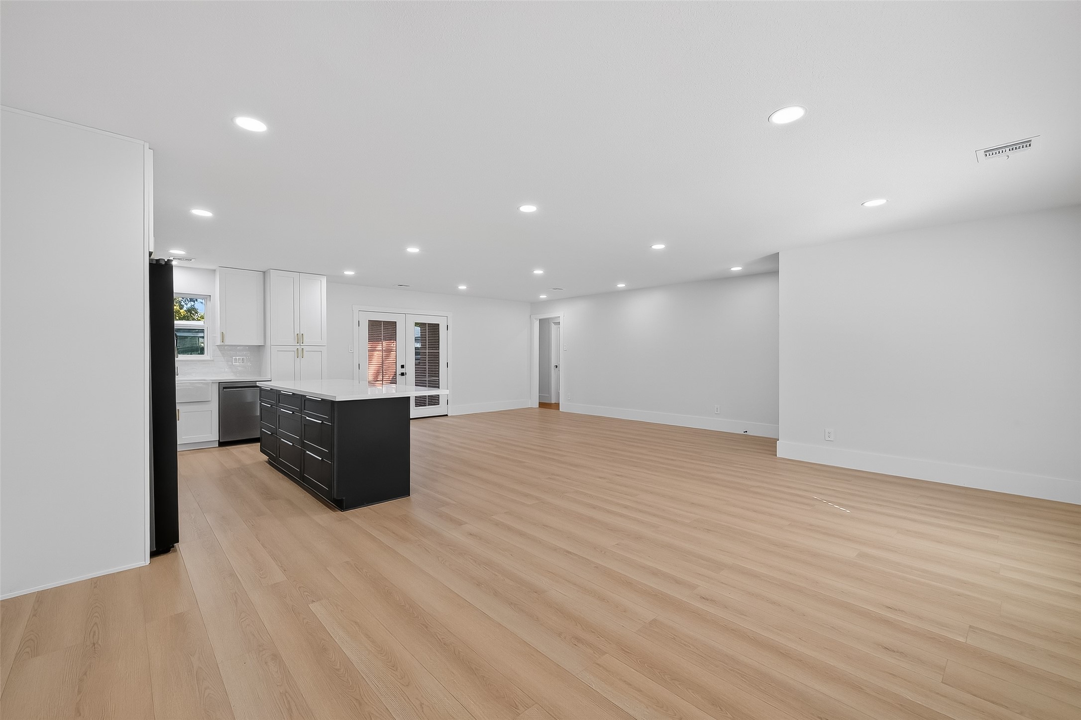 9770 Cedardale Drive Houston, TX 77055 - Photo 10 of 40 a view of kitchen with kitchen island a sink wooden floor and a refrigerator