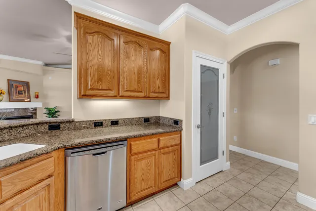a kitchen with stainless steel appliances granite countertop a sink and cabinets with wooden floor