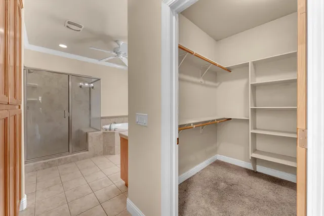 a view of an empty walk in closet and a bathroom
