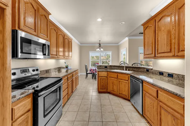 a kitchen with stainless steel appliances granite countertop a stove and a sink