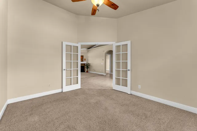 an empty room with a empty space and a ceiling fan