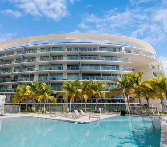 a view of swimming pool with outdoor seating and plants