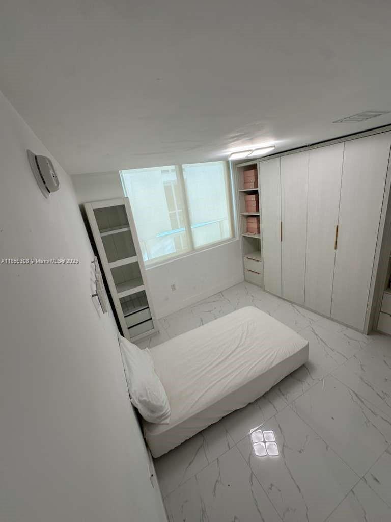 6620 Indian Creek Drive, Unit 616 Miami Beach, FL 33141 - Photo 10 of 19 a bedroom with a bed and a window