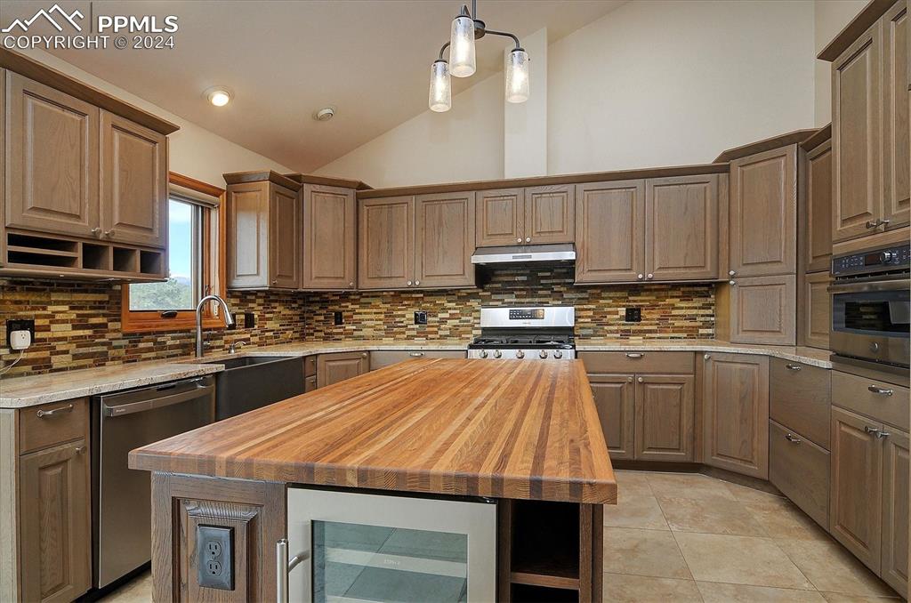 1204 Hitching Post Road Cotopaxi, CO 81223 - Photo 12 of 49 a kitchen with kitchen island granite countertop wooden cabinets a stove a sink and a oven