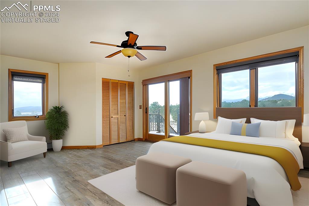 1204 Hitching Post Road Cotopaxi, CO 81223 - Photo 14 of 49 a bedroom with a large bed couch and windows