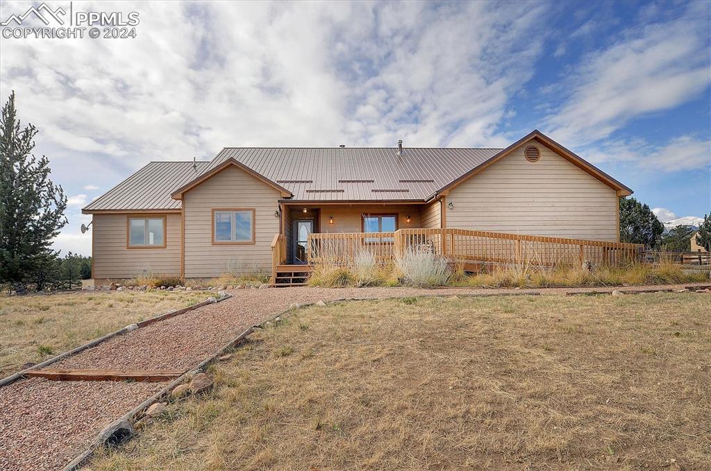 1204 Hitching Post Road Cotopaxi, CO 81223 - Photo 2 of 49 a front view of a house with a dirt yard and garage