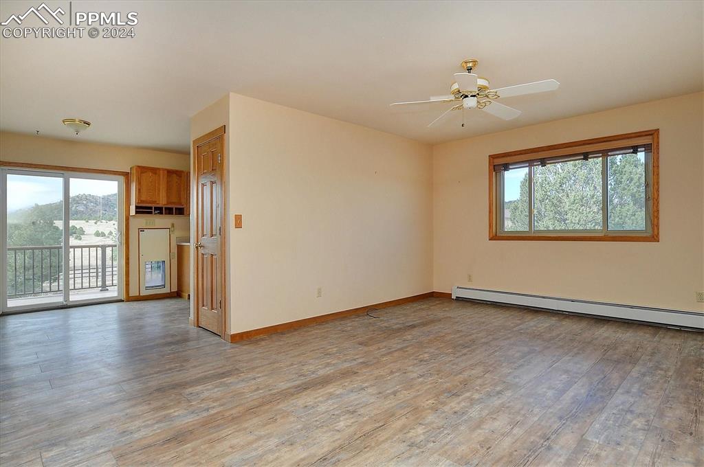 1204 Hitching Post Road Cotopaxi, CO 81223 - Photo 21 of 49 a view of an empty room with wooden floor and a window