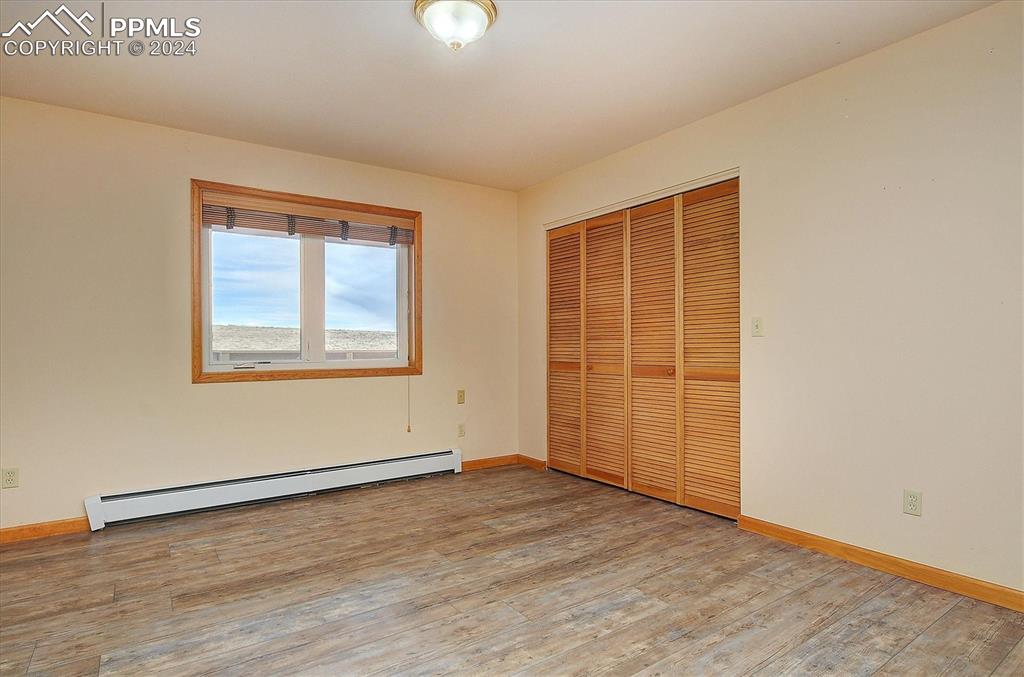 1204 Hitching Post Road Cotopaxi, CO 81223 - Photo 26 of 49 an empty room with wooden floor and windows