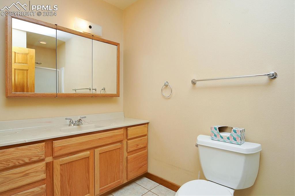 1204 Hitching Post Road Cotopaxi, CO 81223 - Photo 27 of 49 a bathroom with a toilet a sink and mirror